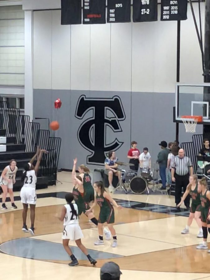 Senior, Elaiyah Badger, shoots the basketball.