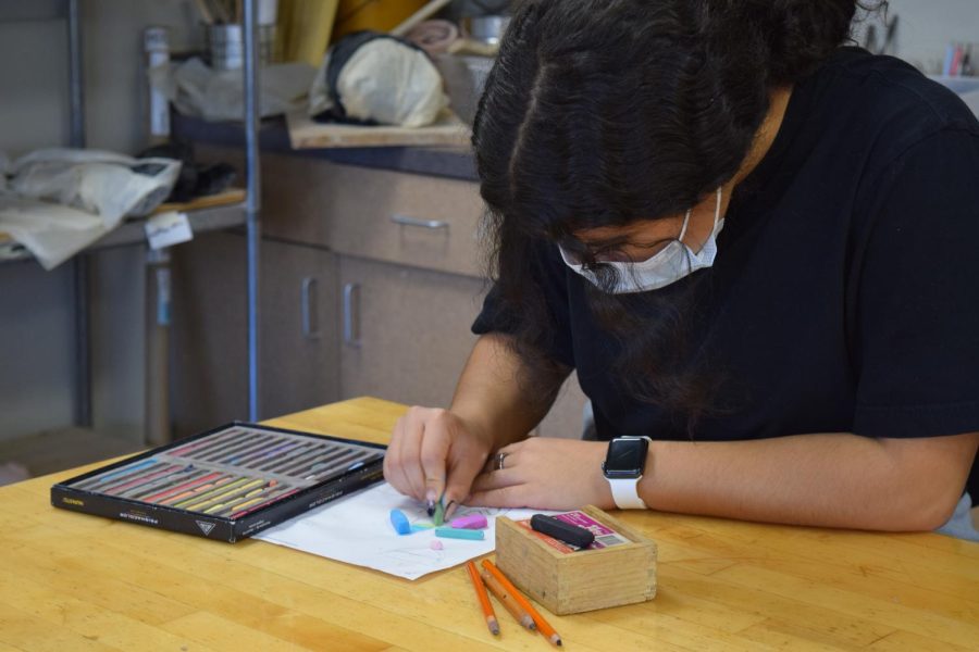 Amira Ruperto works with pastel in the Carbondale Community High School studio spaces.