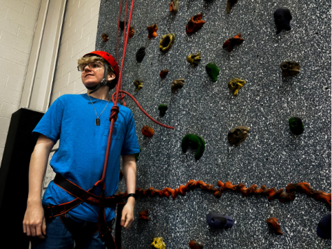 Preparing to climb the rockwall, senior Andrew Shafer of CCHS looks back to his belayer to double check that the belay is ready for him to start climbing. To ensure his safety, he fastens the harness and communicates with his partner.