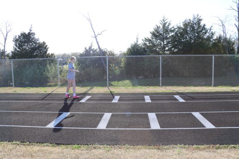 Elsie Hutchinson is  getting in her stance to practice long jump at track practice.