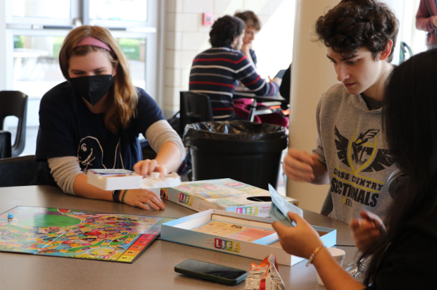 Seniors Lydia Condor and Dow White play a board game at the Low Tardy Party. The new incentive was implemented at CCHS to celebrate students with 2 or less tardies each quarter. Students attending the party played games, ate snacks, and got the chance to win gift cards. Photo by Sarah Russell.