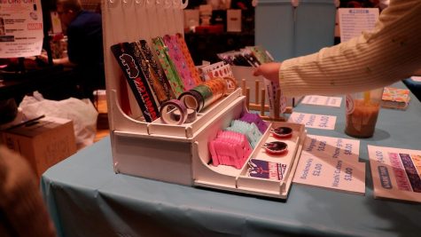 A stand at Saluki-Con selling different items such as bookmarks and stickers.