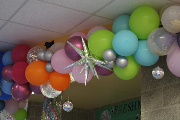 Balloons and disco balls hanging from the front of the freshman hallway decorations