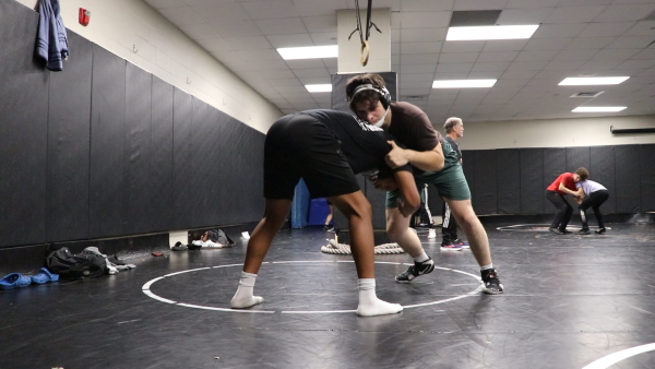 Wrestlers Jonathan Weiderman and Synsear Scott wrestler together for warmups.