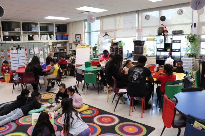 CCHS students reading with elementary students during class